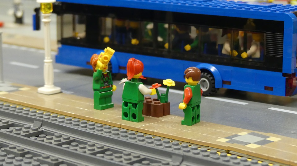 Some legos wait to board a train.